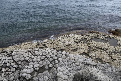 texture of porous stones on the beach, nature, natural phenomena, grey stones, columnar stones, lava rocks                     photo