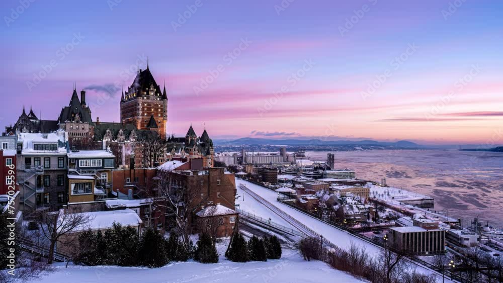 Night to day time lapse of pinky alpenglow over Fairmont Le Château Frontenac in winter morning at Quebec City