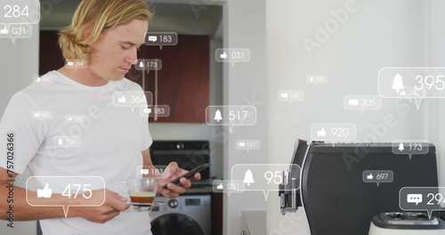 Image of social media notifications over using smartphone having coffee in sunny kitchen