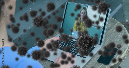 Image of covid 19 cells over businesswoman on laptop image call