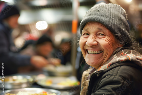 Positive homeless old woman in shelter portrait closeup. Elderly lady vagrant happy to have hot beverage in cold day. Volunteer help photo