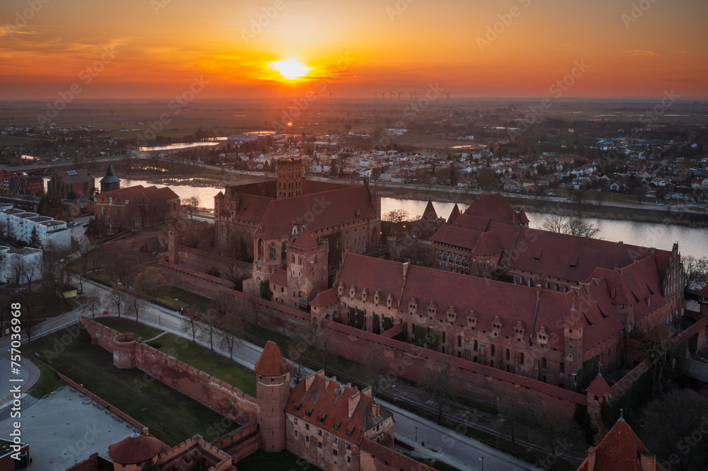 Fototapeta premium Malbork castle over the Nogat river at sunset, Poland