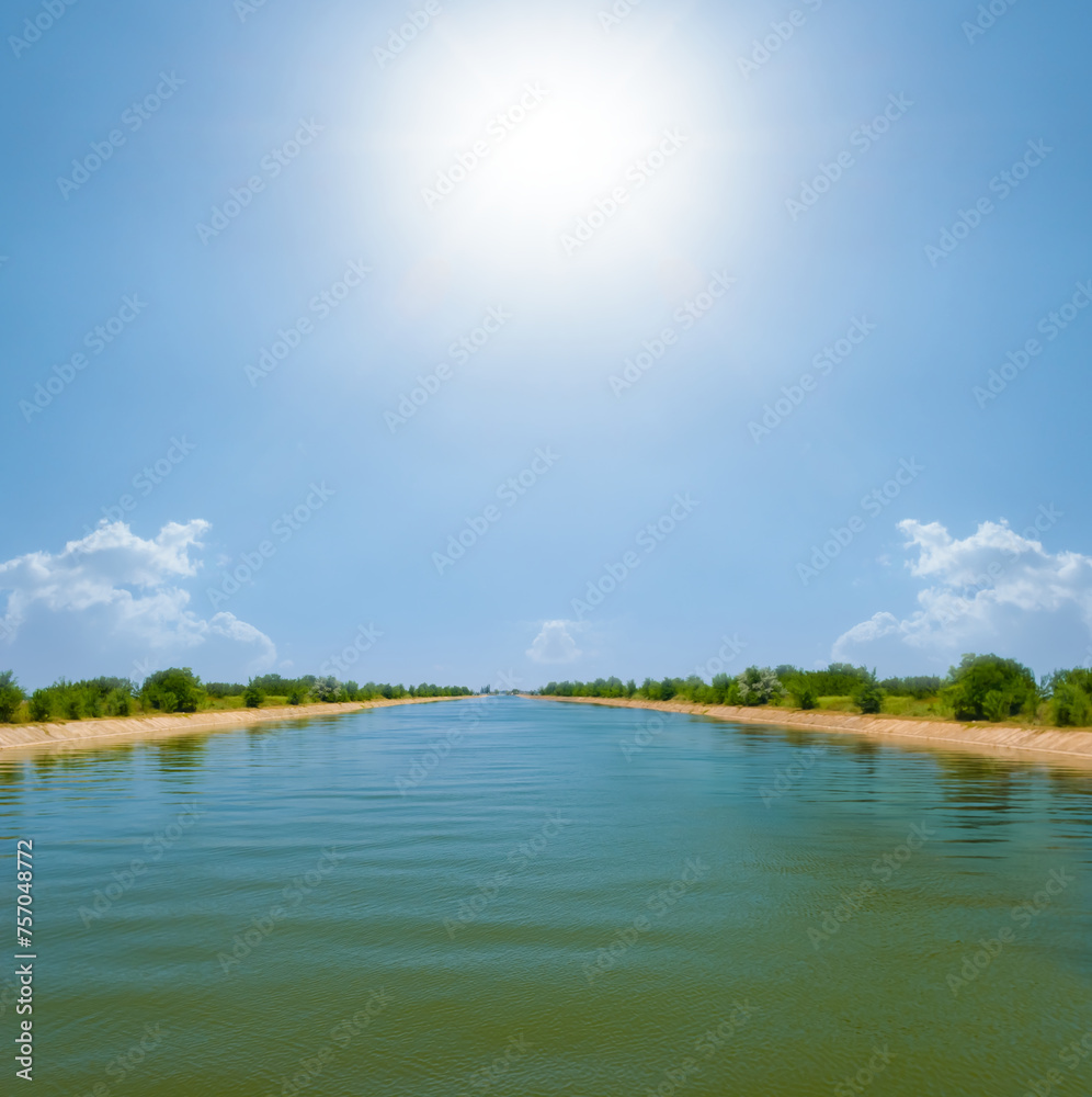 long irrigation channel at summer sunny day