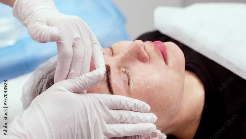 Side view portrait of young attractive woman on procedure for improvements skin. Concept of special masks and creams for moisturizing and improving the skin. Side view portrait of young attractive woman on procedure for improvements skin. Concept of special masks and creams for moisturizing and improving the skin.