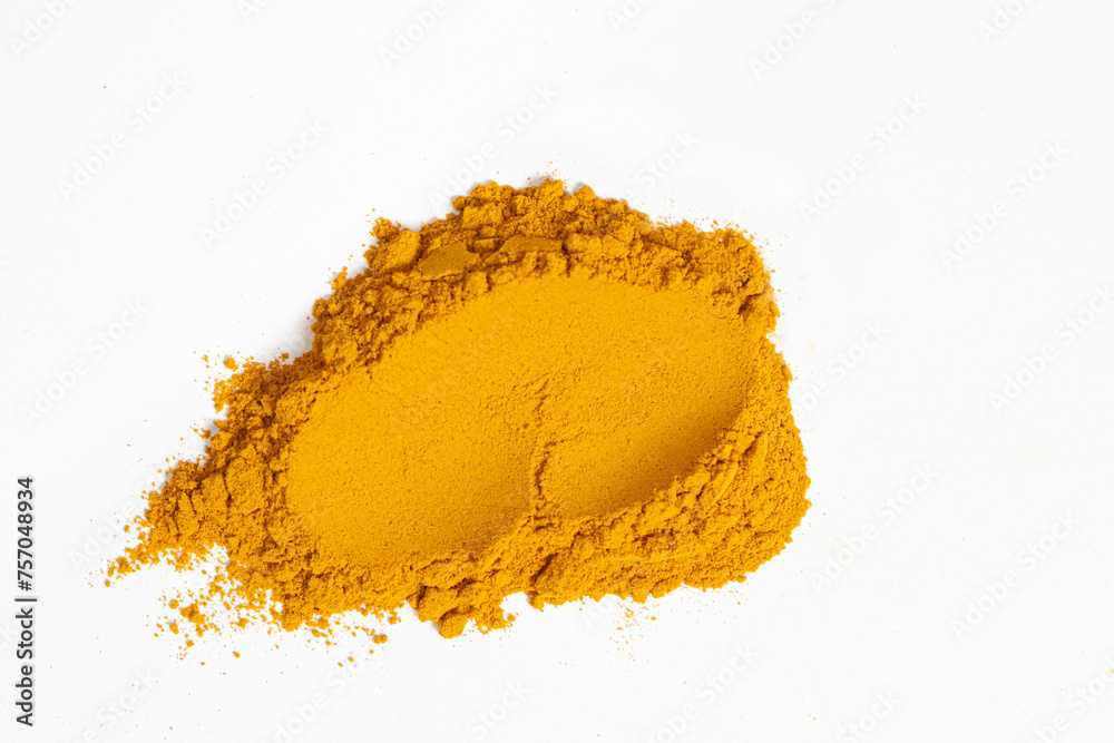 A smear of turmeric on a white background, top view