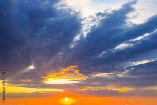 dramatic sunset on cloudy sky background © Yuriy Kulik