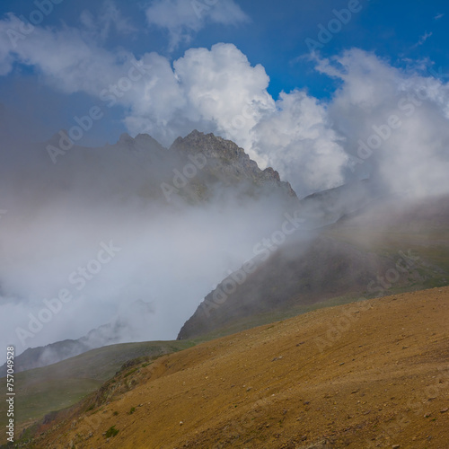 mountain chains in dense mist and shadow, mountain travel background