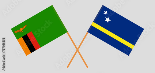 Crossed flags of Zambia and Country of Curacao. Official colors. Correct proportion