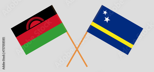 Crossed flags of Malawi and Country of Curacao. Official colors. Correct proportion