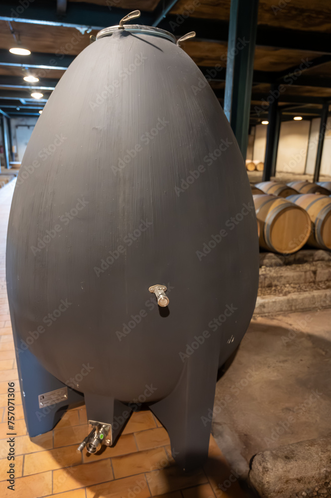 WIne celler with french concrete egg shape wine tank for aging of red wine, Haut-Medoc vineyards in Bordeaux, left bank Gironde Estuary, Pauillac, France