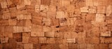 A closeup of a brown rectangle piece of wood that resembles a puzzle, reminiscent of brickwork. Building material with an artistic font, found in a landscape or archaeological site