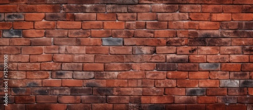 A detailed closeup of a brown brick wall showcasing intricate brickwork and symmetry. The blurred background highlights the pattern and texture of the building material