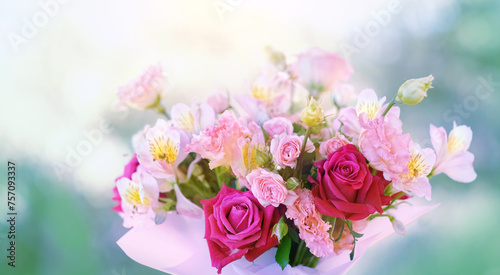beautiful floral bouquet in gentle pink-magenta colors close up on abstract blurred natural background. romantic floral festive image. template for design