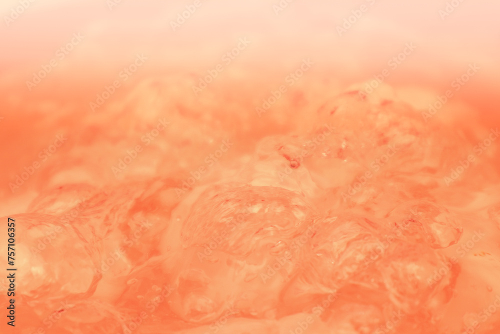 Fototapeta premium Abstract nude and peach fuzz color gradient background. Water surface. Clear water surface texture with splashes and bubbles.