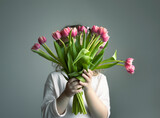 Child holding bouquet of flowers, kid with tulips.Spring holiday concept.Mother's day.Women's day.