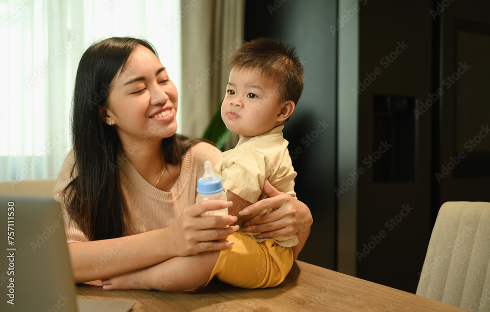 Beautiful young mother spending time with her little son at home. Motherhood and child care concept Beautiful young mother spending time with her little son at home. Motherhood and child care concept