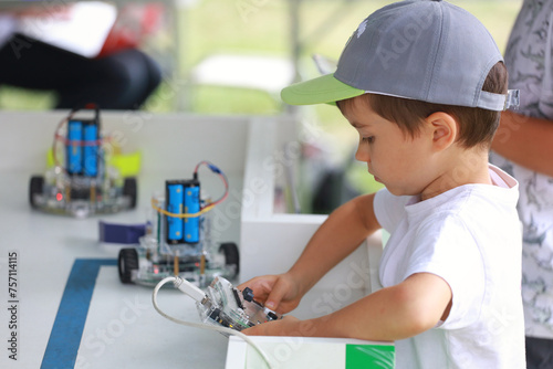 A boy plays with programmable robots