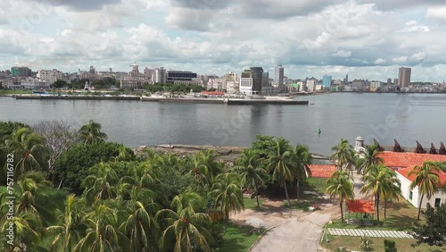 Panorama of Havana capital city in Havana with Malecon promenade and Bahia de la Habana bay, panning shot photo