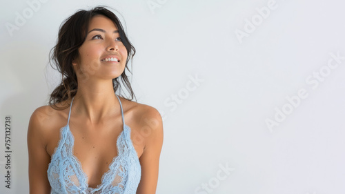 Hispanic woman in blue lace halter dress smile isolated on gray background
