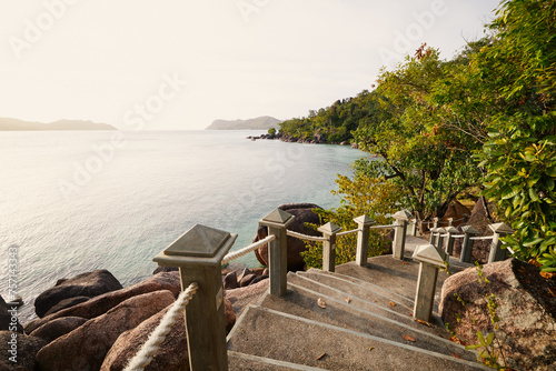 Stairs leading to idyllic beach. Coastal landscape on coast of Seychelles.
