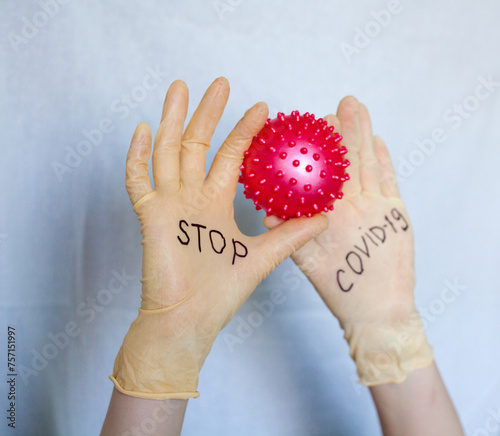 Stop Covid-19. Text on medical gloves.