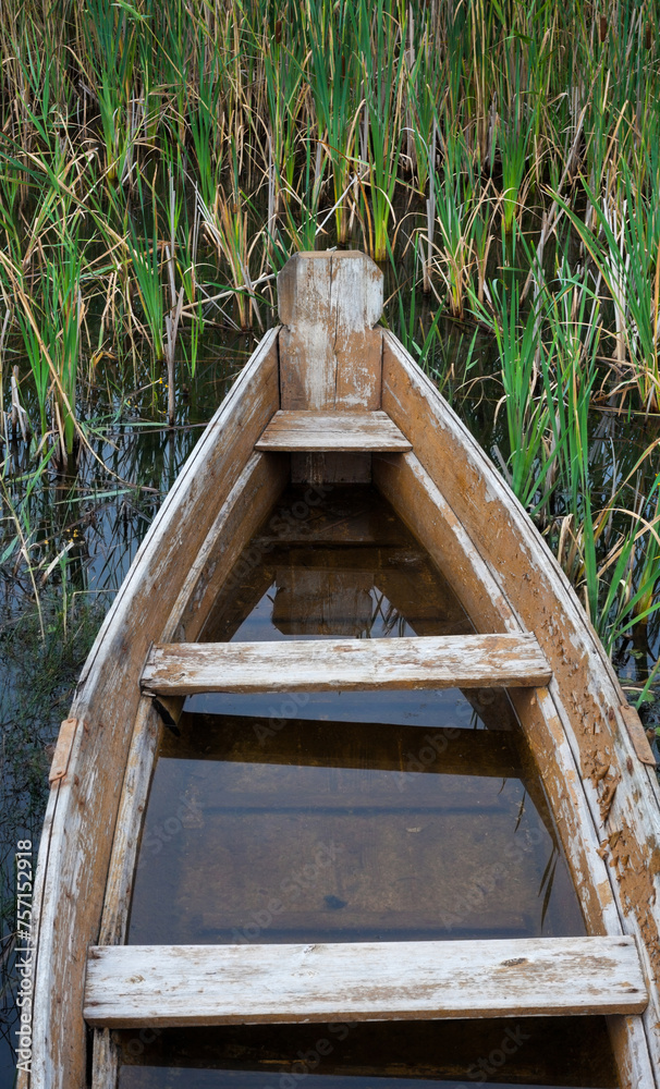 Old broken wooden boat filled with water Old broken wooden boat filled with water