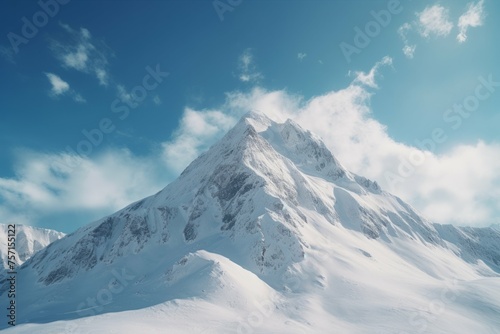 Snow-covered mountain peak with blue sky and clouds. © Michael Böhm