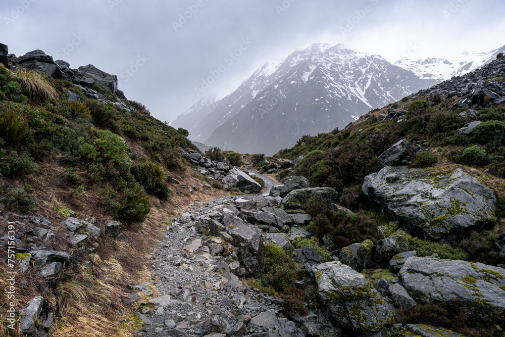 View of rainy hike to Kea Point lookout, Mount Cook National Park, New Zealand. Dramatic landscape, misty trails, perfect for adventure, nature, and outdoor enthusiasts.