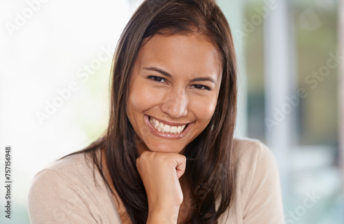 Free Download Happy woman, portrait and relax with positive attitude or natural beauty in living room at home. Face of young female person, brunette or model with smile for holiday, break or weekend at the house - GFXLoad