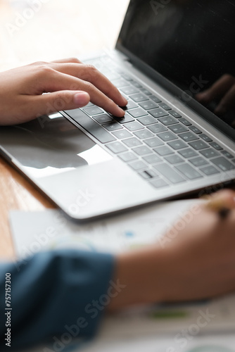 Close up of hands of diverse people on office desk work together on laptop discussing ideas, multiethnic businesspeople negotiate brainstorm using computer cooperating at meeting. Partnership concept