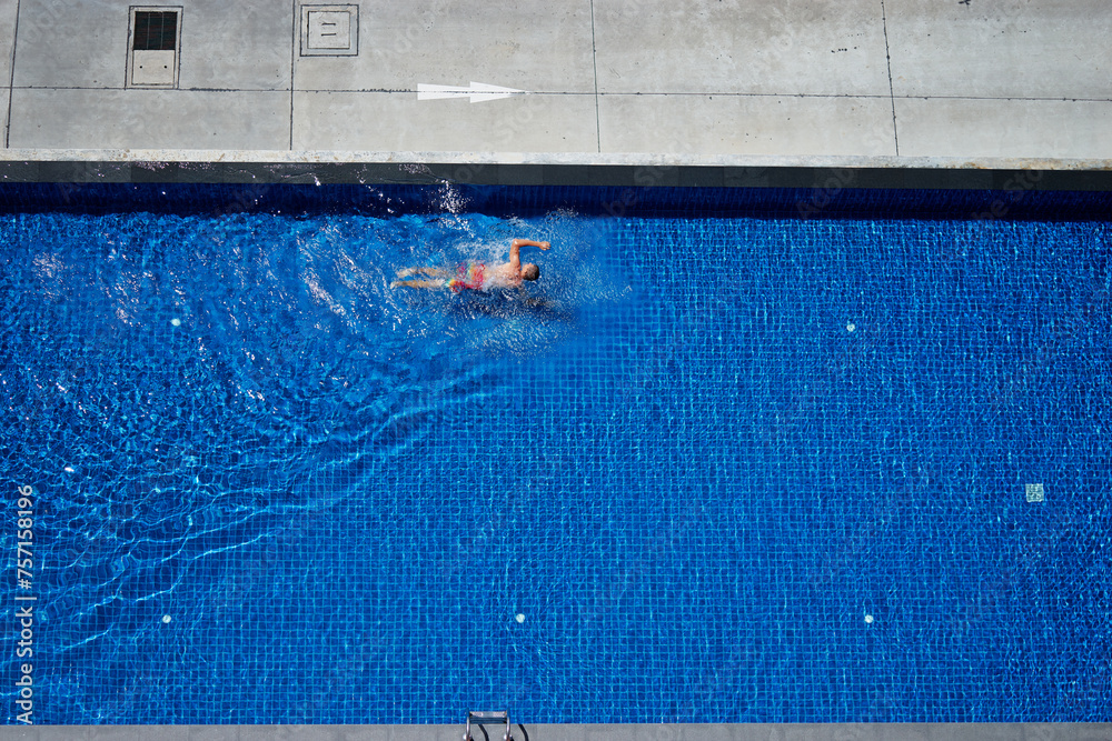  Healthy fitness. Top view of man swimming in the pool.