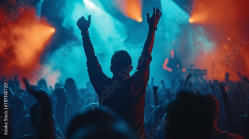 a man raising his hands in front of a crowd