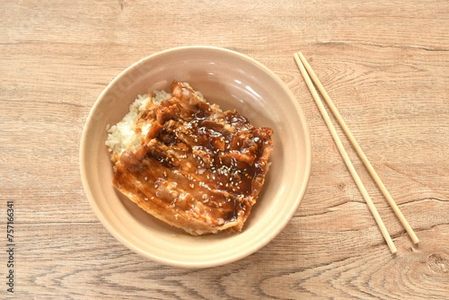 roasted slice pork bacon dressing Teriyaki Japanese sauce on rice in bowl