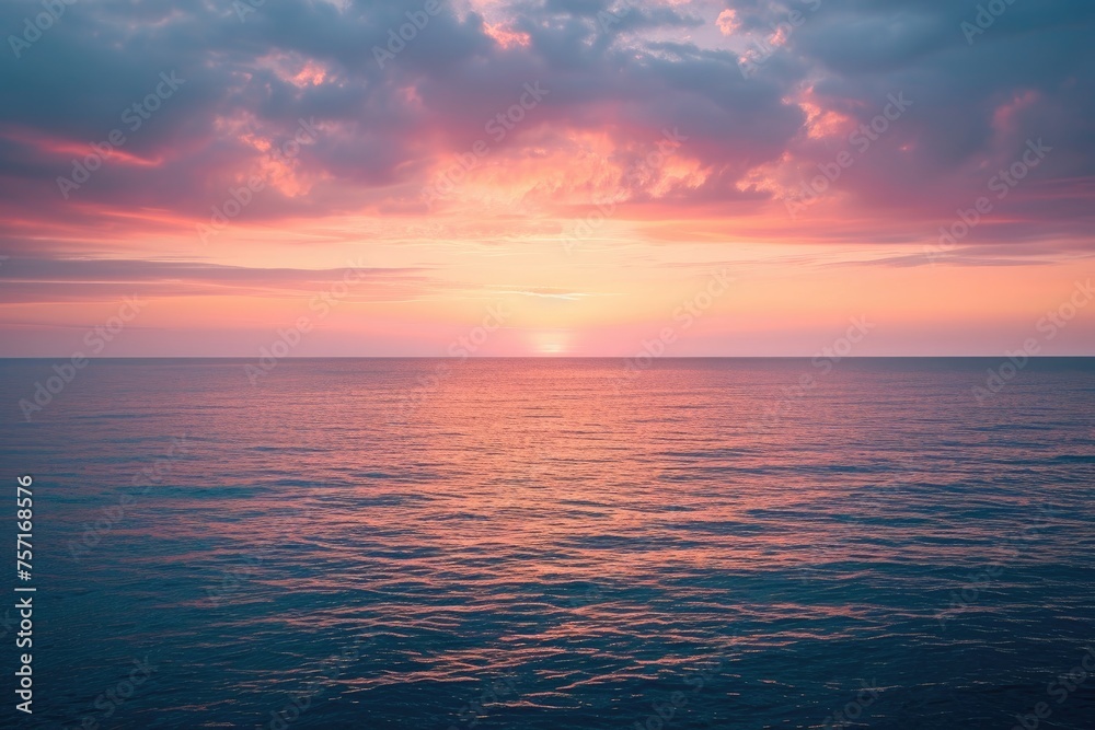 Witness the captivating sight of the sun setting over the ocean on a cloudy day, beautifully merging the celestial and aquatic realms, A gentle blend of sunset hues over a placid ocean, AI Generated