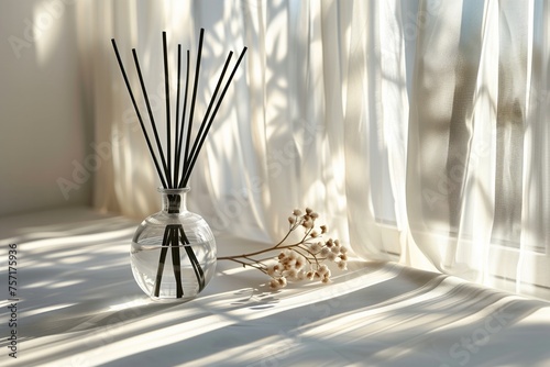 A glass diffuser bottle with black rattan sticks, minimalism, concept quiet luxury. Sunlight from window. Concept aromatherapy and relaxing. Air freshener. Copy space for text. 