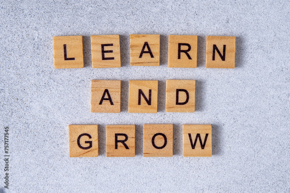 Learn and grow phrase made of wooden letters. Words. Learn and grow phrase made of wooden letters. Words.