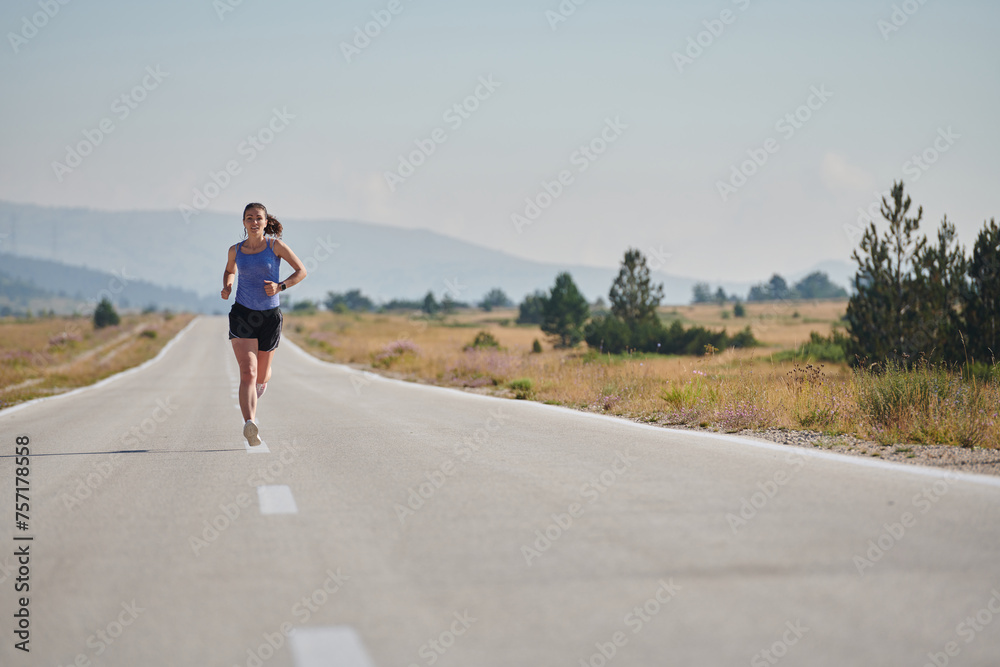 Obraz premium A determined woman athlete trains for success in the morning sun.