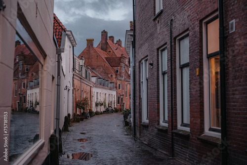 Amersfoort Netherlands, March 26 2023: Historic medieval city center on a rainy day. Narrow street with medieval houses in the historic center of Amersfoort at dusk.