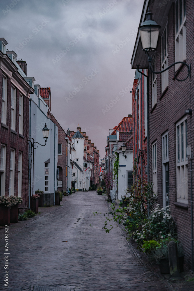Amersfoort Netherlands, March 26 2023: Historic medieval city center on a rainy day. Narrow street with medieval houses in the historic center of Amersfoort at dusk.