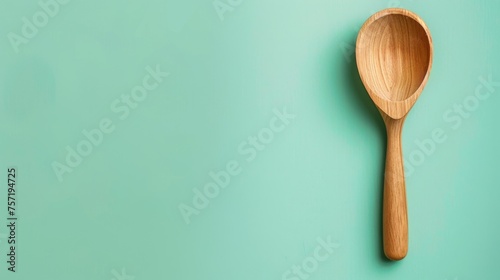 A rustic wooden spoon rests peacefully on a vibrant green surface