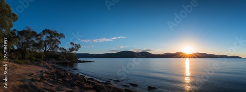 View of the sea and mountains with the evening sun © paisorn