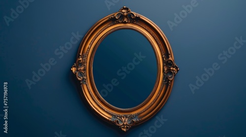 A luxurious gold oval mirror hanging on a vibrant blue wall