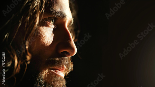 A close-up on the face of the resurrected Jesus, half in shadow and half illuminated, capturing the mystery and majesty of the moment, with copy space