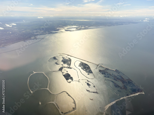 Fototapeta Naklejka Na Ścianę i Meble -  Aerial view of new land made in lake in The Netherlands, holland. Dikes and islands form a bird sanctuary in IJsselmeer. Marker Wadden as part of water management