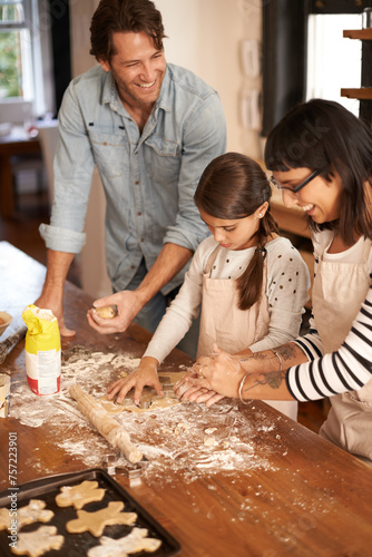 Parents, kid and happy with bake biscuits in kitchen for easter season or bonding, child development and growth. Home, family and flower or dough for cookies with fun, teaching and support on holiday