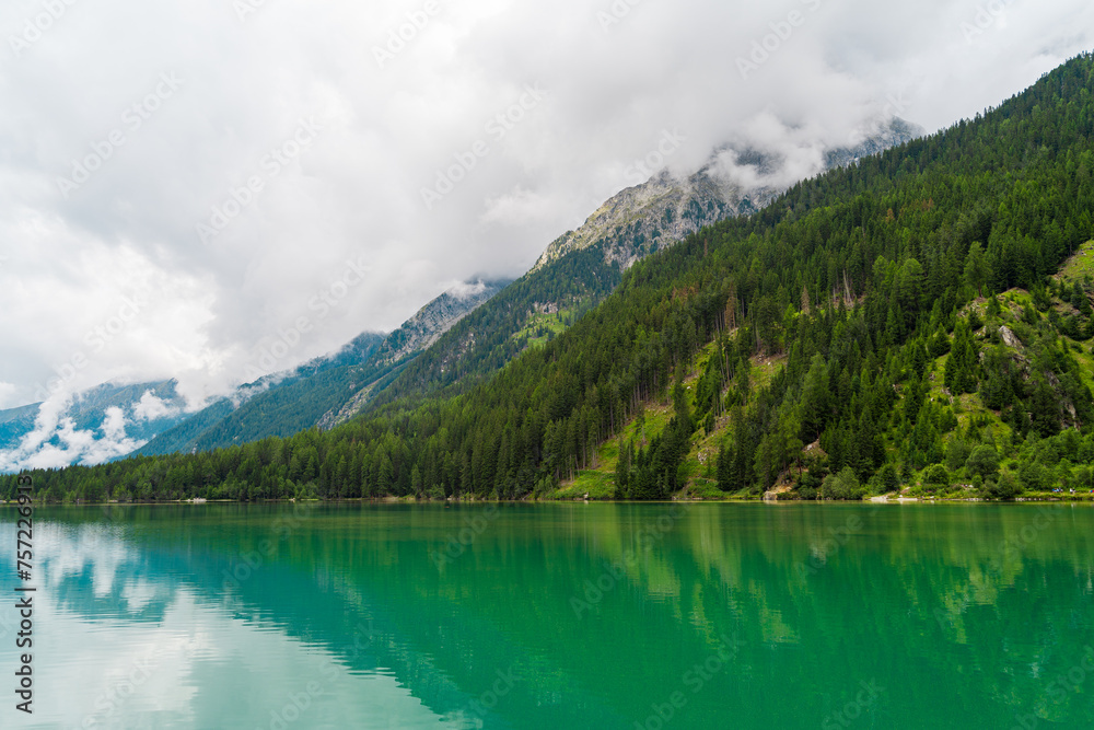 Majestic Antholzer See Surrounded by Alpine Mountains on a Cloudy Day
