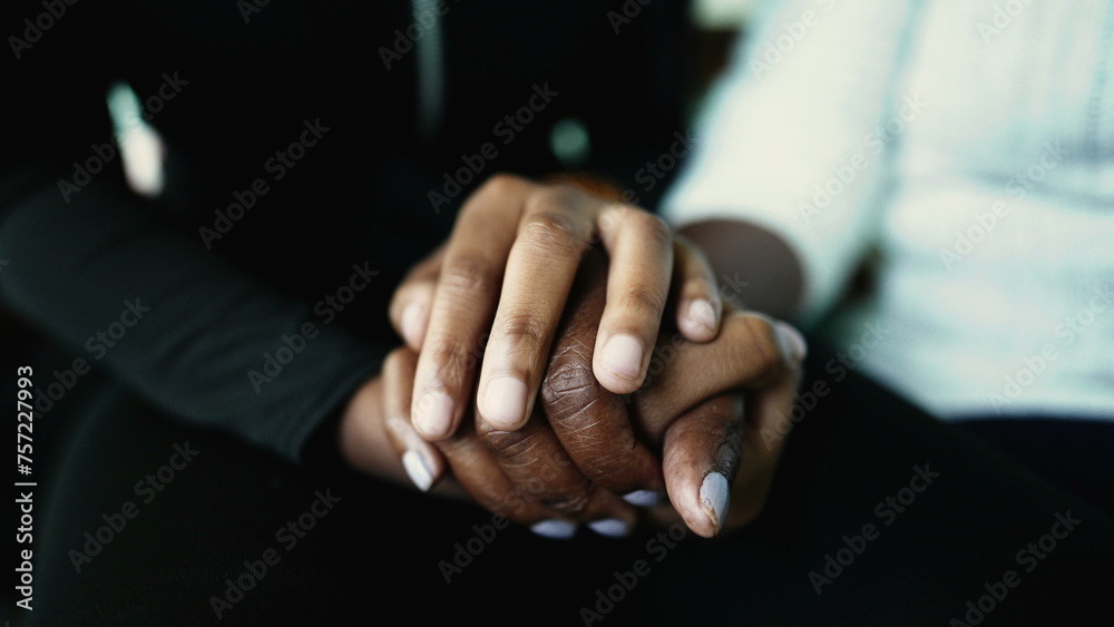 Macro closeup detail of hands held together in support and help during senior age. Grand-daughter hand holding elderly grandmother's wrinkled hand showing love