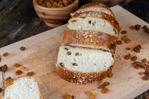 sweet bun with golden raisins, closeup photo