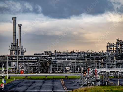 Complex industrial maze under a brooding sky