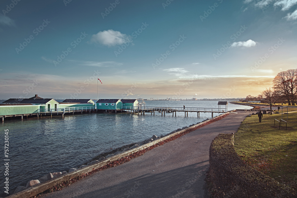 Serene coastal view at sunset with a wooden pier Serene coastal view at sunset with a wooden pier